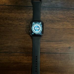 Apple Watch series 6 44mm with five different bands and power charger.